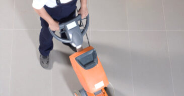 man-worker-cleaning-floor-with-s